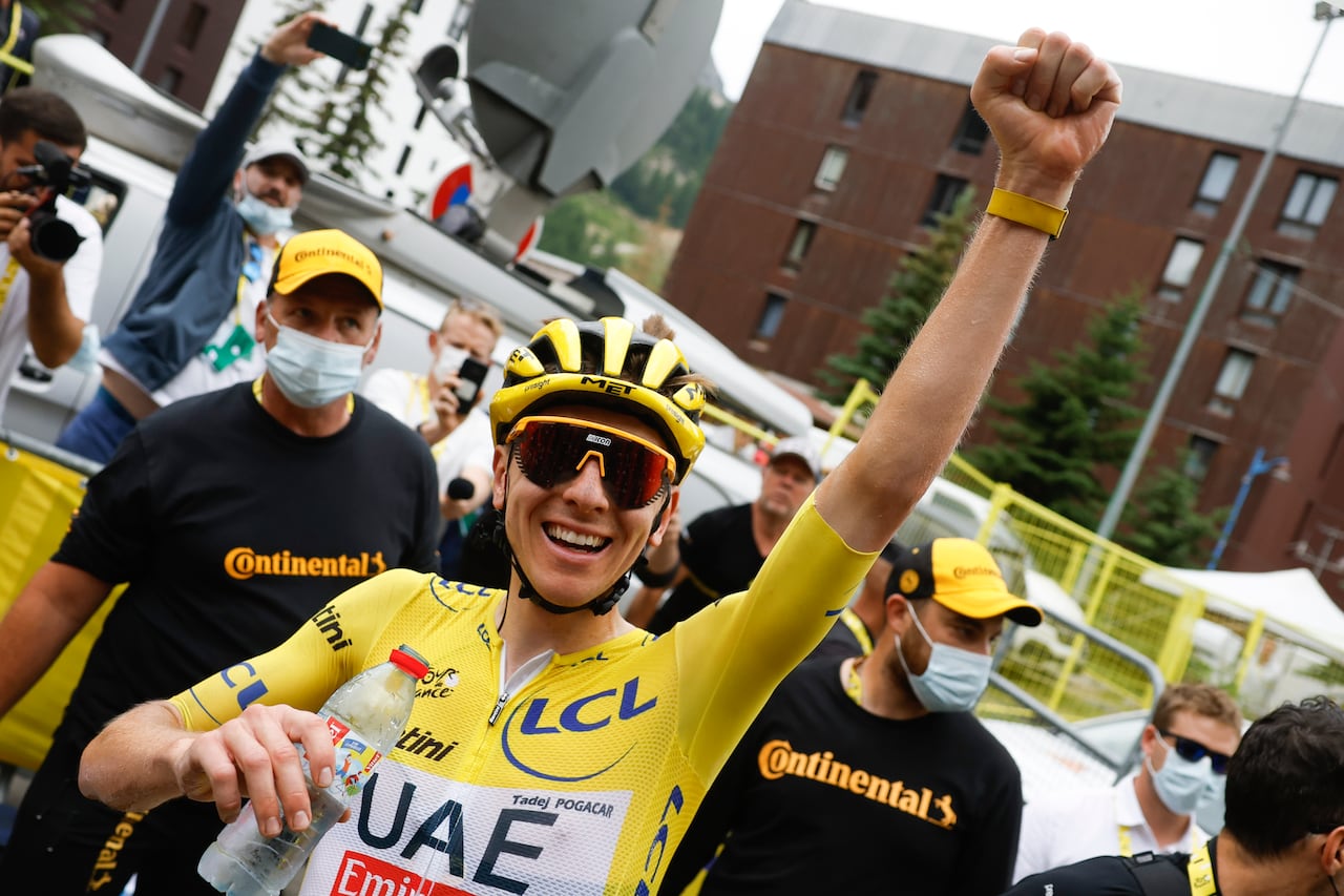 Slovenia's Tadej Pogacar, wearing the overall leader's yellow jersey, celebrates after crossing the finish line to win the nineteenth stage of the Tour de France cycling race over 144.6 kilometers (89.9 miles) with start in Embrun and finish in Isola 2000, France, Friday, July 19, 2024. (Stephane Mahe/Pool Photo via AP)