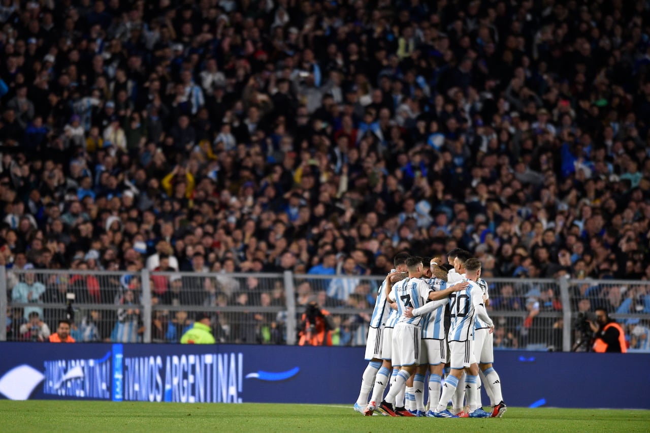 Players of Argentina surround Nicolas Otamendi after he scored the opening goal in a qualifying soccer match for the FIFA World Cup 2026 against Paraguay at the Monumental stadium in Buenos Aires, Argentina, Thursday, Oct. 12, 2023. (AP Photo/Gustavo Garello)