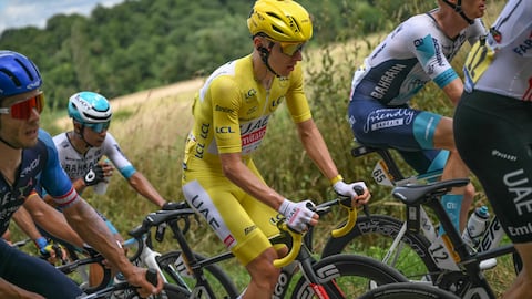 UAE Team Emirates team's Slovenian rider Tadej Pogacar wearing the overall leader's yellow jersey cycles with the pack of riders (peloton) during the 13th stage of the 111th edition of the Tour de France cycling race, 165,3 km between Agen and Pau, southwestern France, on July 12, 2024. (Photo by Marco BERTORELLO / AFP)